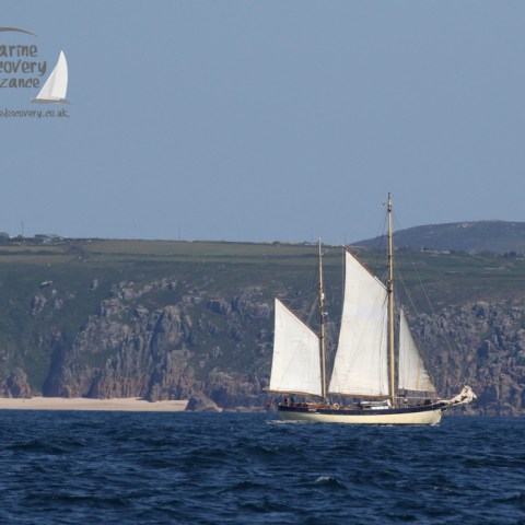 traditional vessel sailing past Porthcurno