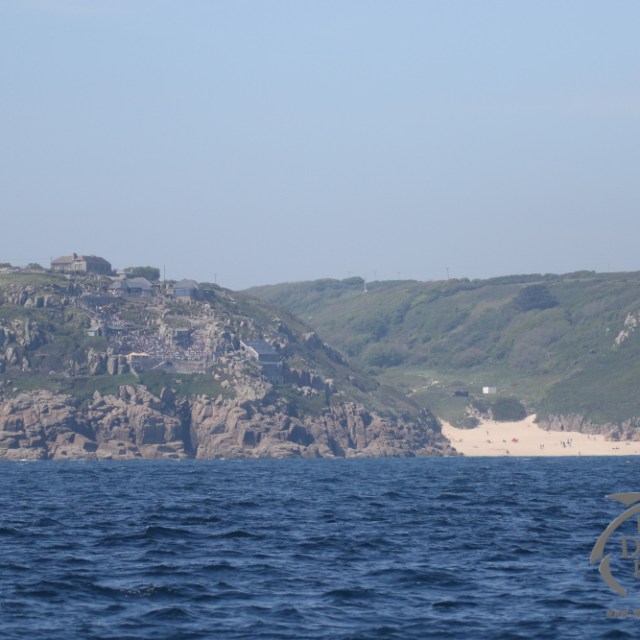 a large body of water with a mountain in the background