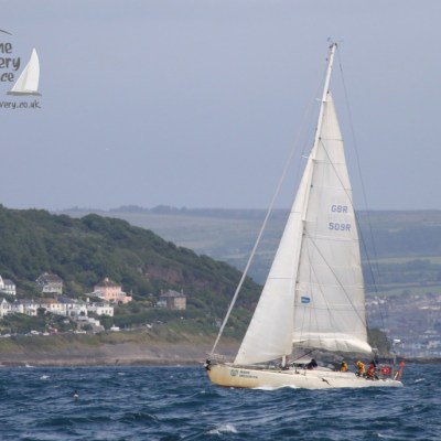yacht sailing past Mousehole
