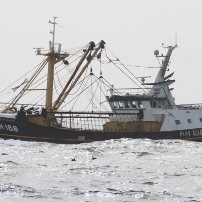 Fishing trawler RM 188 navigating through choppy sea waves.